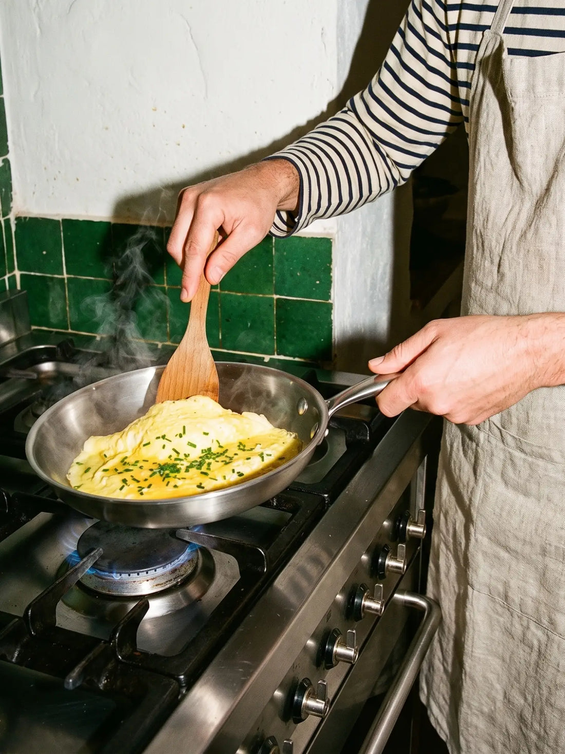 Omelette baveuse à la ciboulette travaillée à la spatule en bois dans la poêle inox 20 cm SAINE, sur feu gaz