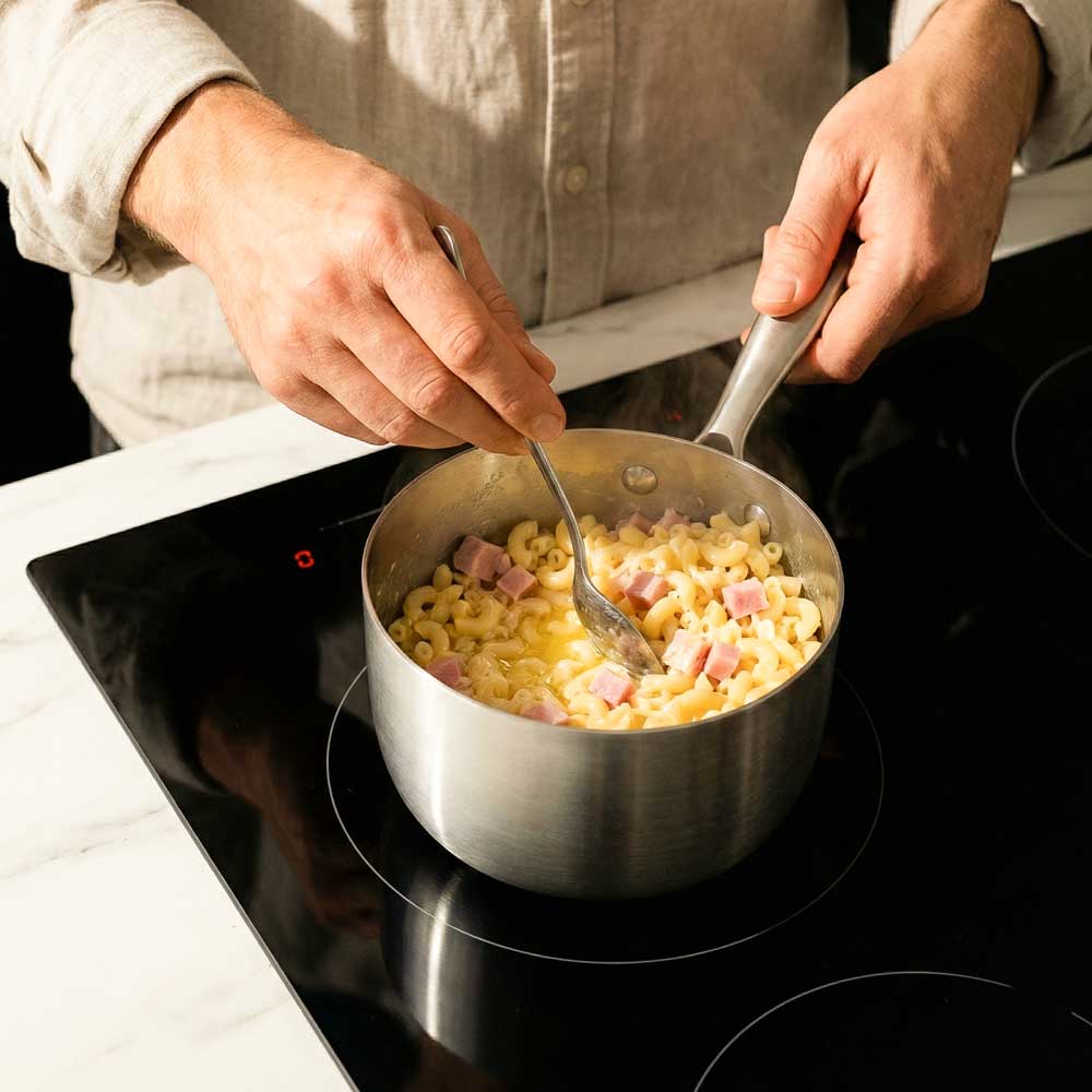 cuisson de pates coquilettes au jambon dans une petite casserole inox
